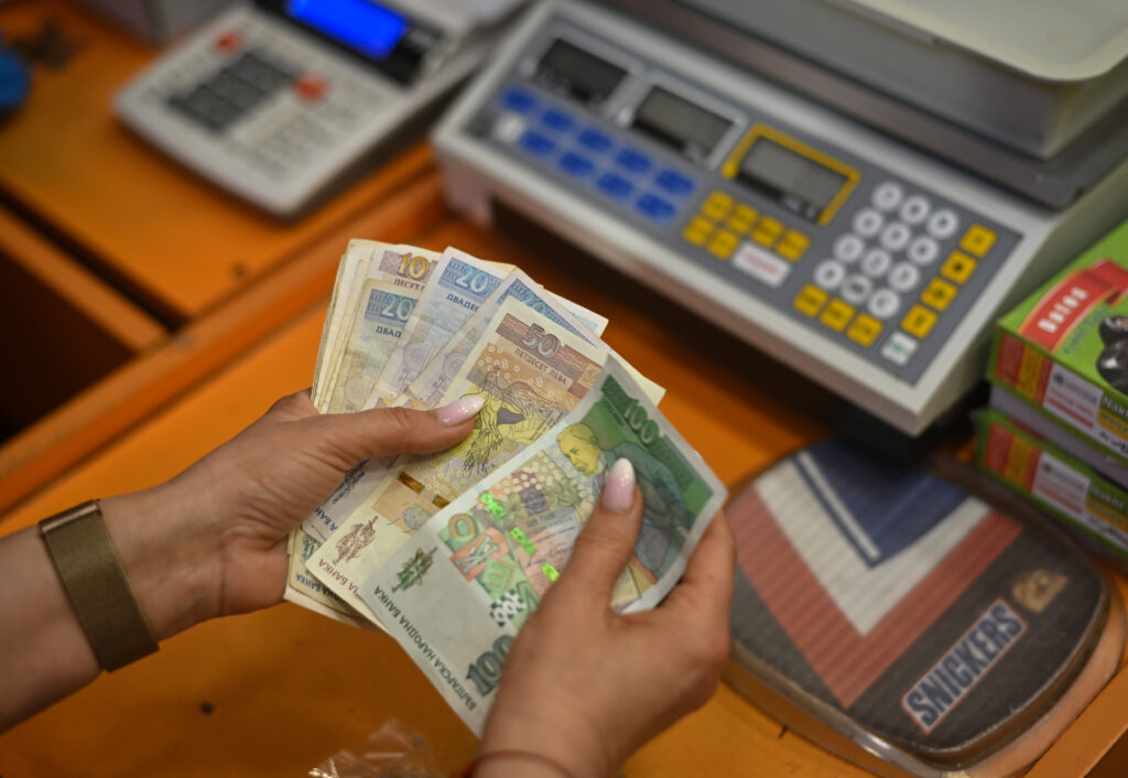 A worker counts Bulgarian Lev banknotes at a store in Sofia, Bulgaria, on Friday, March 29, 2024.