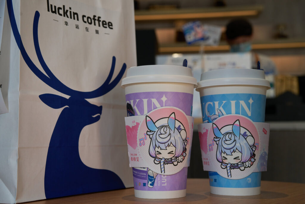 Two cups of coffee on table in a Luckin Coffee store.